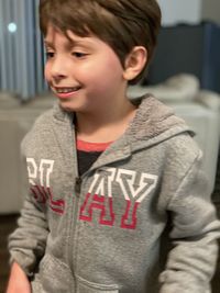 Portrait of smiling boy standing at home