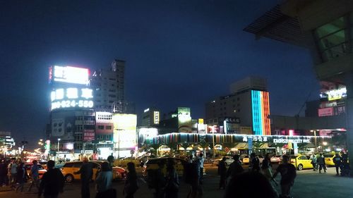 Crowd on illuminated city at night