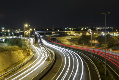 Long exposure shot of highway at night, with cars driving in the road