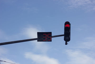 Low angle view of road sign against sky