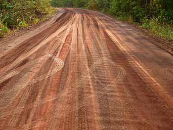 High angle view of tire tracks on dirt road