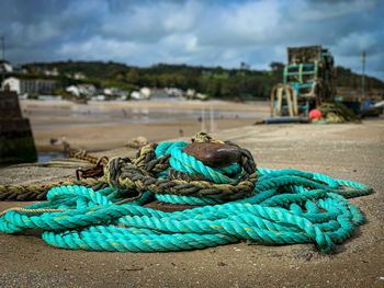 Close-up of rope tied to bollard on pier