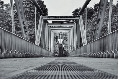Man on bridge against sky