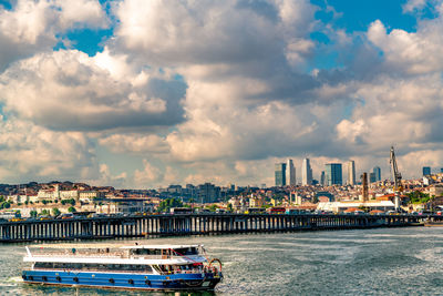 Panoramic view of sea and buildings against sky