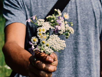 Close-up of hand holding flower