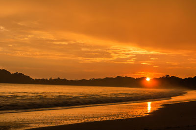 Scenic view of sea against romantic sky at sunset