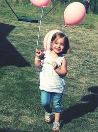 Portrait of happy girl playing with balloons