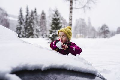 Portrait of girl in snow covered park during winter