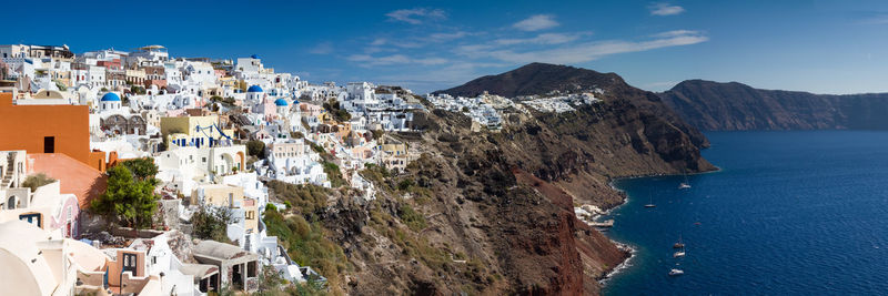 Panoramic shot of townscape by sea against sky