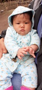 Portrait of cute baby girl with mother outdoors