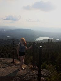 High angle view of girl standing at observation point against landscape