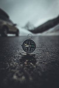 Close up of compass on road