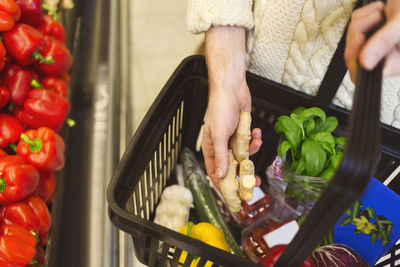 Midsection of man buying groceries at supermarket