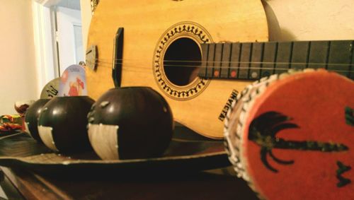 Close-up of guitar on table