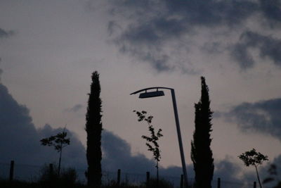 Low angle view of silhouette trees against sky during sunset