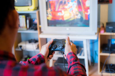 Man playing video game while sitting at home