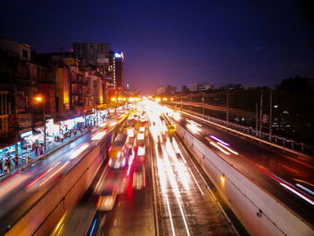 High angle view of light trails on highway at night