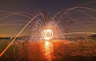 Light trails against sky at dusk