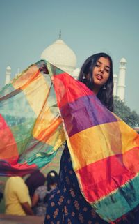 Low angle view of woman standing against the sky