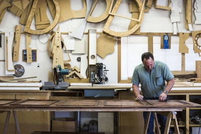 Confident carpenter working at workshop