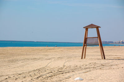 Lifeguard hut on beach against clear sky