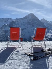 Lifeguard hut on snowcapped mountain against sky