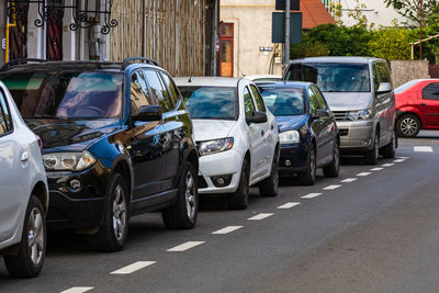 View of vehicles on road along buildings