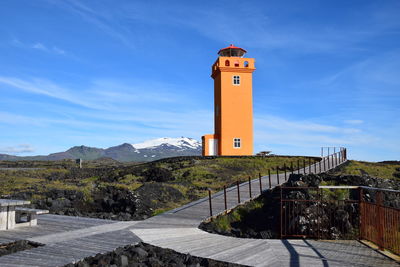 Lighthouse against cloudy sky