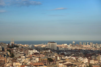 High angle view of townscape by sea against sky