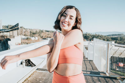 Portrait of smiling young woman standing outdoors