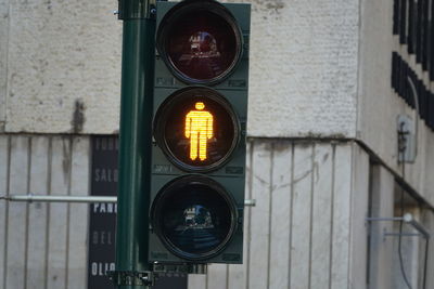 Close-up of road sign against building