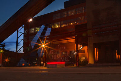 Illuminated road in city at night