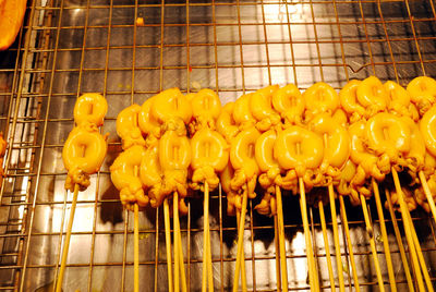 Low angle view of yellow meat on barbecue grill