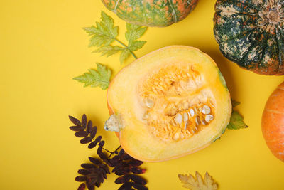 Close-up of orange fruits against yellow background