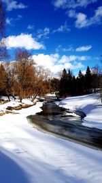 Scenic view of snowcapped mountains against blue sky