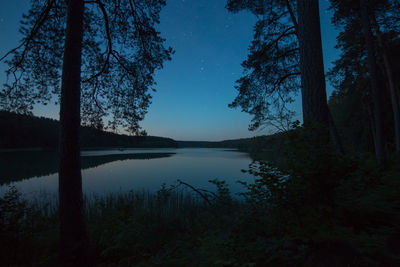 Scenic view of lake against sky at night