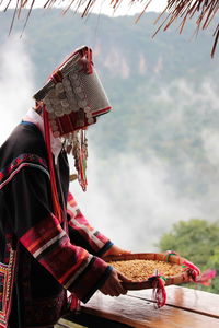 Man in traditional clothing against sky