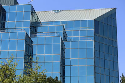 Low angle view of modern buildings against clear sky