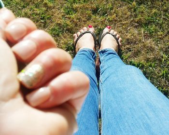 Low section view of woman standing on grass