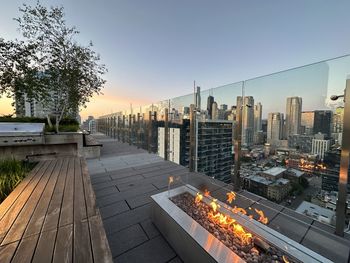 High angle view of cityscape against clear sky fire pits on luxury roof deck