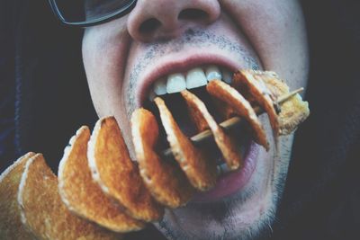 Close-up of man eating food