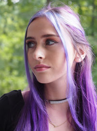 Close-up of beautiful woman looking away while standing outdoors