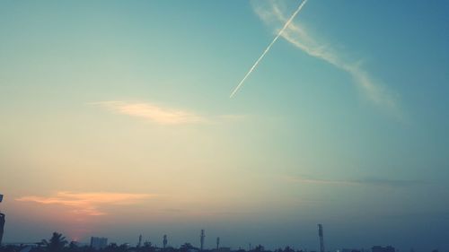 Low angle view of landscape against sky at sunset