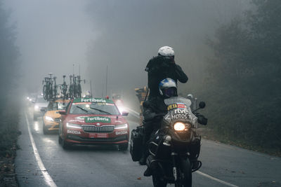 People on street in city during foggy weather