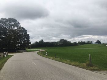 Empty road along countryside landscape