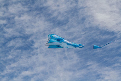 Low angle view of bird flying against blue sky