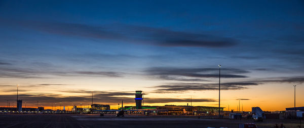 View of buildings against cloudy sky at sunset