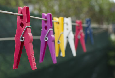 Close-up of multi colored clothespins hanging