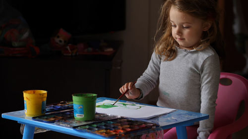 Midsection of girl holding table