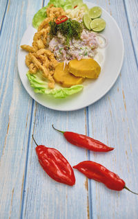 Peruvian food, fish ceviche and chicharron de pescado with fried cassava, sweet corn